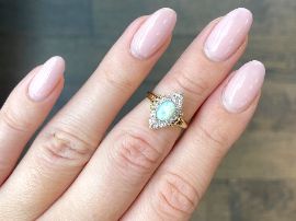 opal ring on finger