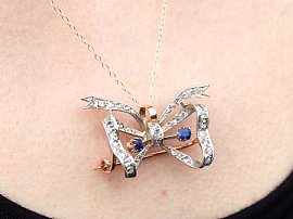 Antique Bow pendant with Sapphires and Diamonds wearing