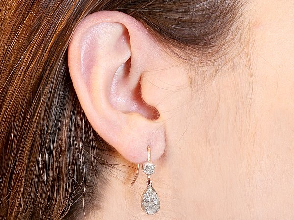 silver drop earring with brown hair