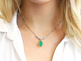 wearing pear cut emerald pendant