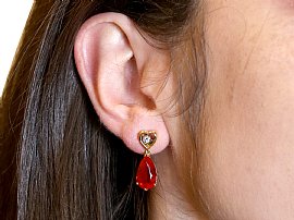 Wearing Pear Cut Fire Opal Earrings in Gold