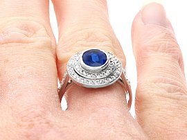 Oval Sapphire Ring with Diamond Halo on hand