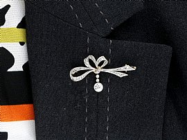 wearing diamond bow brooch