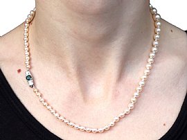 wearing Pearl Strand Necklace with Green Sapphire Clasp