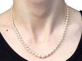 Pearl Strand Necklace with Green Sapphire Clasp wearing