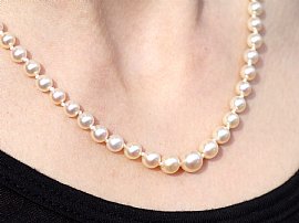 wearing Pearl Strand Necklace with Green Sapphire Clasp