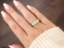 Three Stone Opal Ring in Yellow Gold wearing 