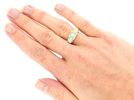 Three Stone Opal Ring in Yellow Gold wearing 