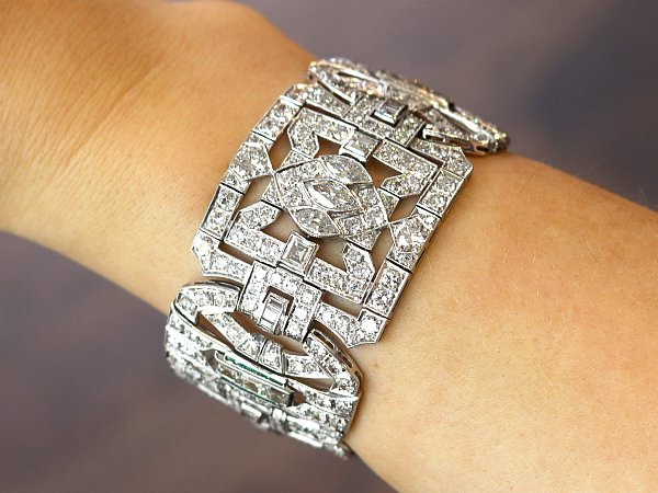 Art Deco diamond and emerald bracelet on wrist 