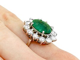 4.83 carat emerald cluster ring on hand